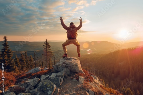 Happy hiker man with arms up jumping on the cliff. celebration of a young man success hiking mountain. photo