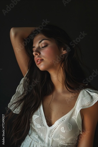 A woman in a white dress posing for a picture. Suitable for fashion or portrait photography projects