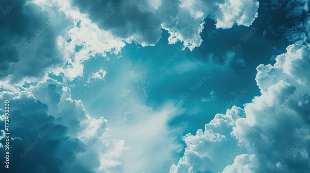 Fototapeta premium A plane flying through a cloudy blue sky. Suitable for travel or aviation concepts