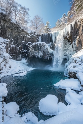 A beautiful frozen waterfall in a snowy forest, perfect for winter themes