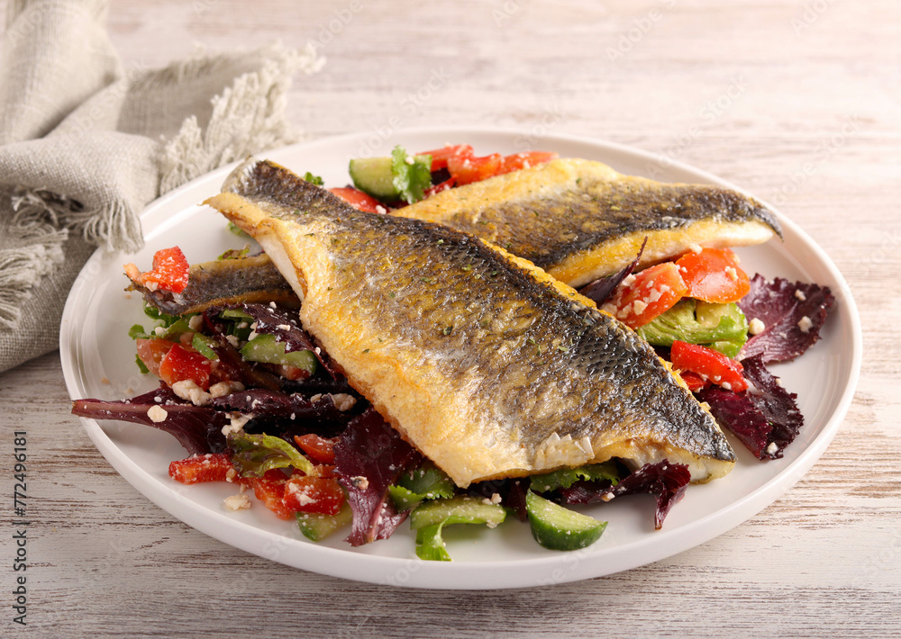 Fried seabass fillet over salad, Fried seabass fillet over salad,