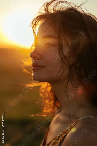 A woman with her eyes closed and her hair blowing in the wind. Suitable for beauty and relaxation concepts