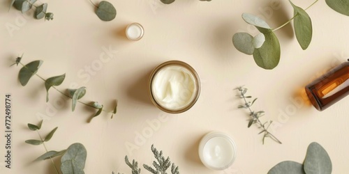 Cream jar surrounded by greenery and candles, suitable for spa concept
