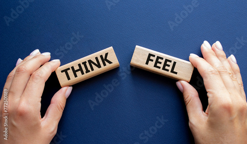 Think or Feel symbol. Concept word Think or Feel on wooden blocks. Businessman hand. Beautiful deep blue background. Business and Think or Feel concept. Copy space