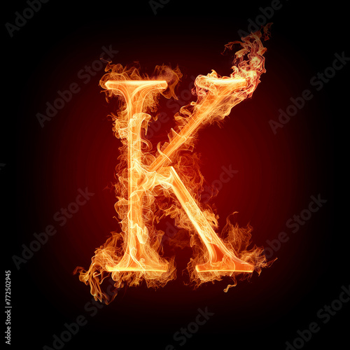 Letter K made of fire flames with sparks isolated on black background
