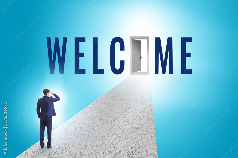 Fototapeta premium Businessman on the road leading to welcome sign