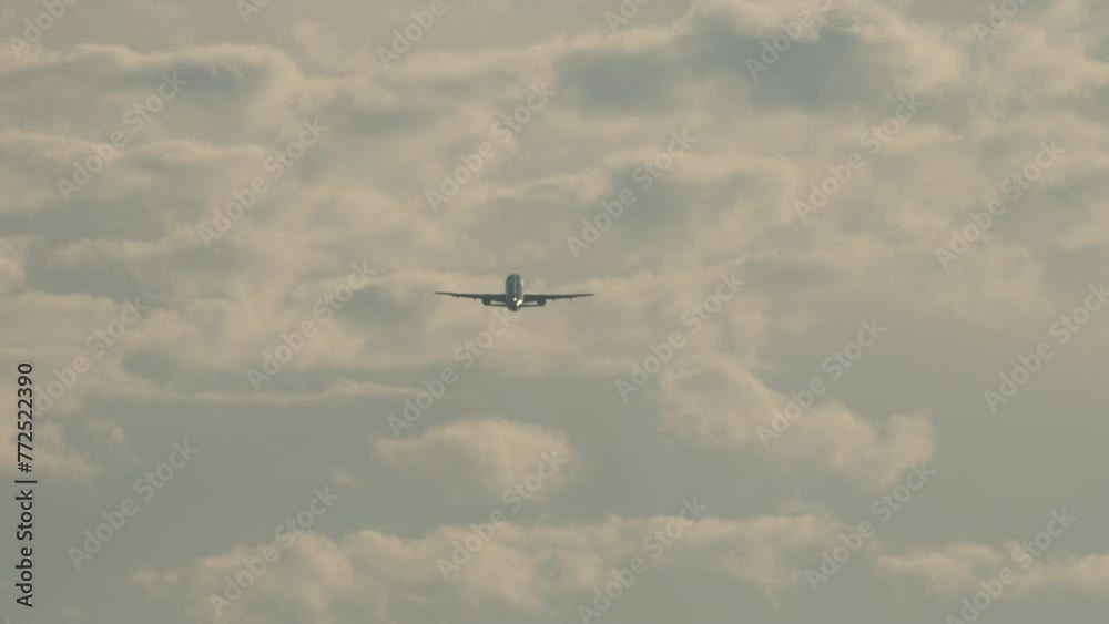 Long shot rear view, jet passenger plane with unrecognizable livery climbing after takeoff. Air transport in backlight Long shot rear view, jet passenger plane with unrecognizable livery climbing after takeoff. Air transport in backlight