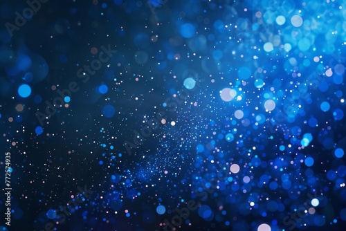 Abstract blue background with bokeh lights and glittering particles. Festive and magical, perfect for Christmas or holiday-themed designs