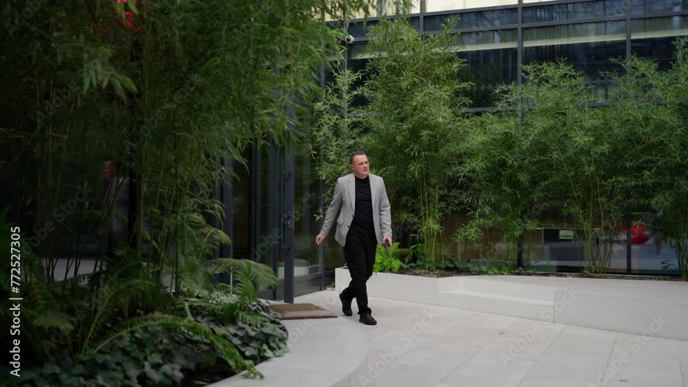 Dynamic Businessman Exiting Office to Lush Courtyard. A dynamic man exits the office door, stepping into a serene courtyard surrounded by bamboo. Dynamic Businessman Exiting Office to Lush Courtyard. A dynamic man exits the office door, stepping into a serene courtyard surrounded by bamboo.