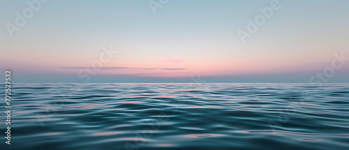 Soft waves of the ocean under a gradient sunset sky from pink to blue, evoking calm and peace