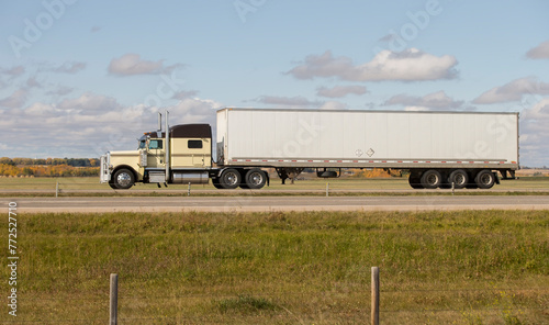 Heavy Cargo on the Road. A truck hauling freight along a highway. Taken in Alberta, Canada