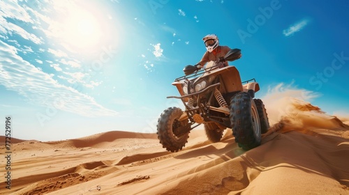 Low angle view of a man riding quad bike in desert against the blue sky
