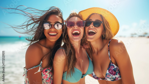 Three smiling girls have fun on the summer beach © Cla78