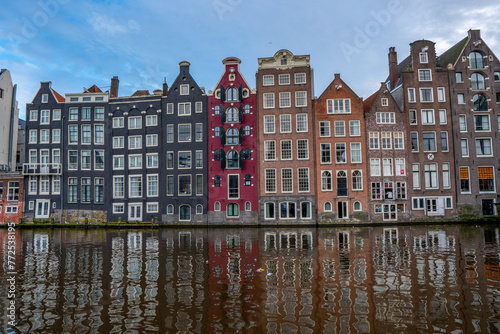 Amsterdam downtown - Amstel river, old houses and a bridge. Travel to Europe. Holland, Netherlands, Europe.