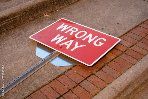 Wrong Way sign laying on the sidewalk in Marion, Virginia