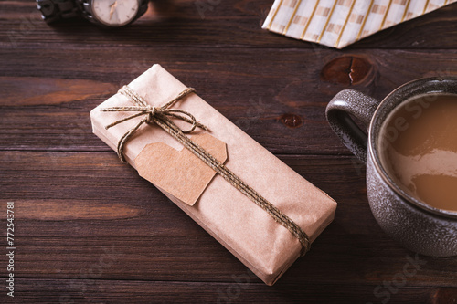 Father's day craft gift with cardboard heart next to coffee mug on wooden table