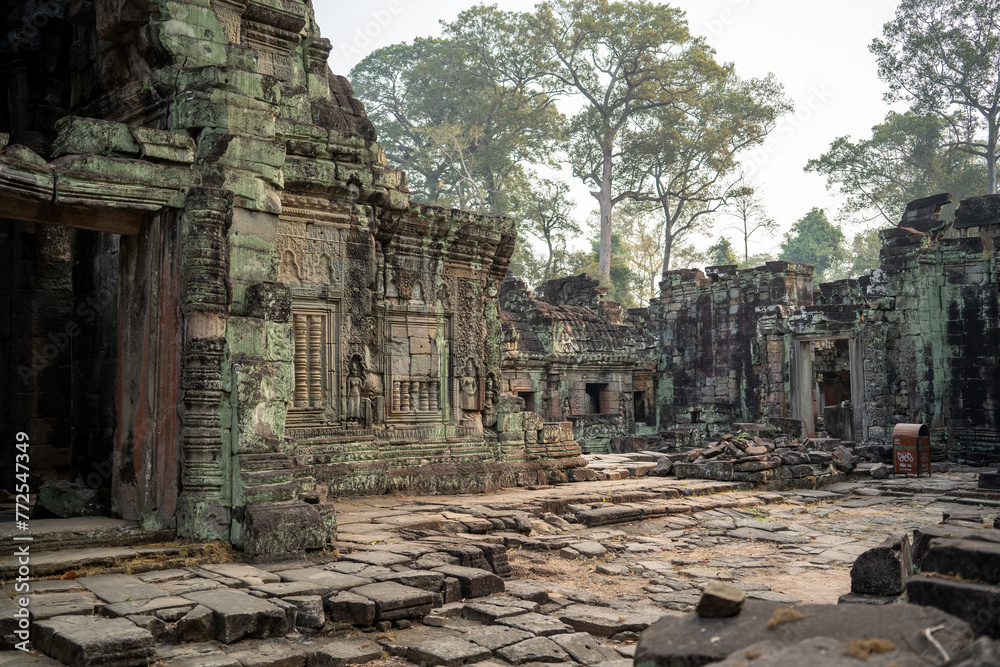 Sunrise light shining through at Temple in Angkor complex Cambodia