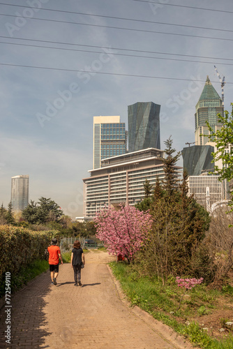 Atasehir District of Istanbul, Turkey View of The Botanic Garden,  high rise buildings of Financial Center in the background at sunny winter day © aydinsert