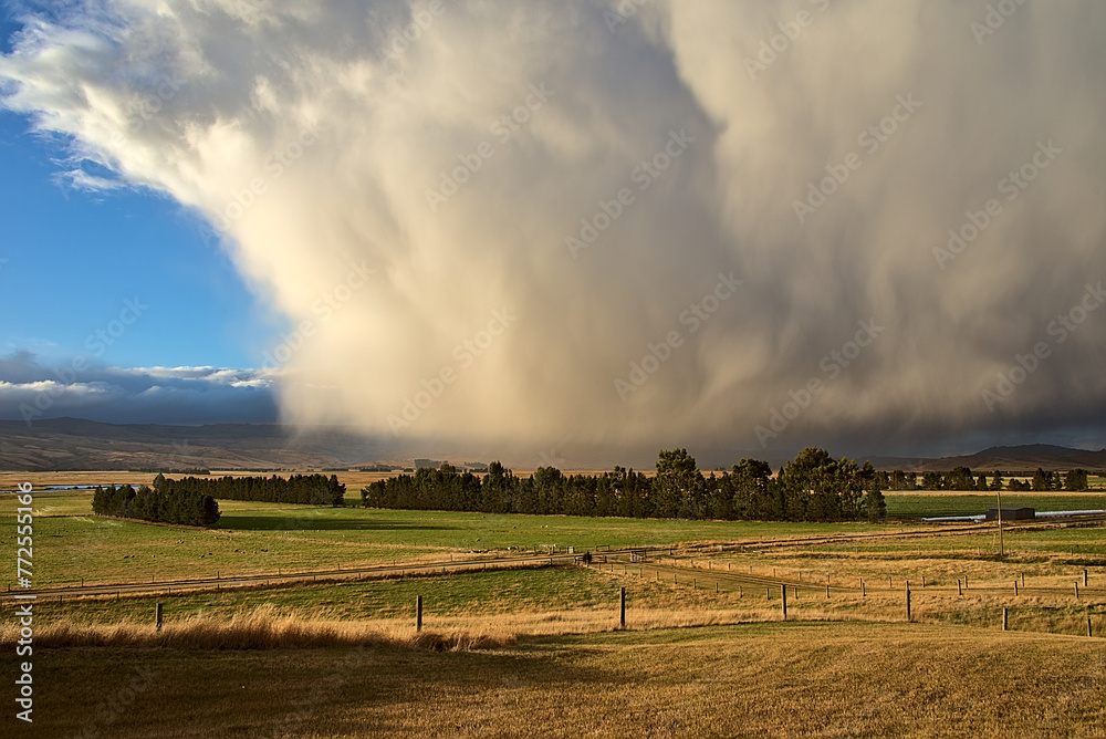 Fototapeta premium A large storm cloud over a field