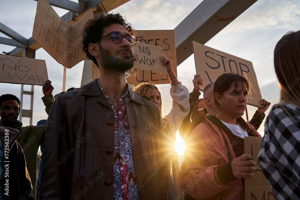 Image of a diverse group of activist people at an anti-war protest ...