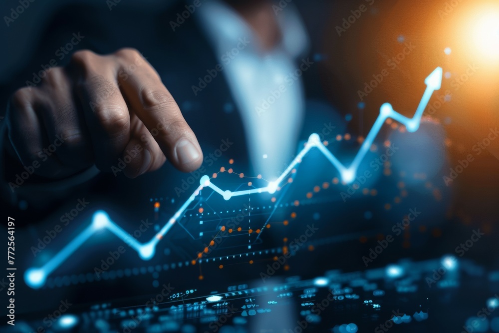 A man is pointing at a graph on a computer screen A man is pointing at a graph on a computer screen