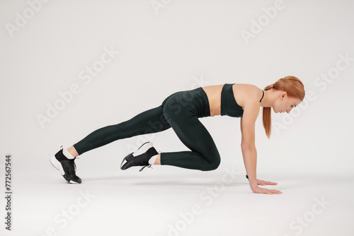 athletic girl doing stretching before training