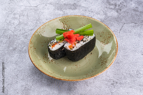Onigirazu with salmon in a plate on a gray background