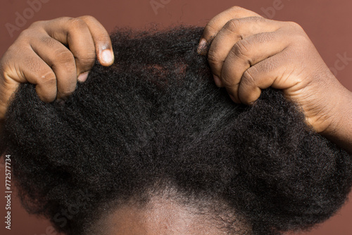 Detangling black afro curly hair with shrinkage, Type 4c hair being detangled and stretched out