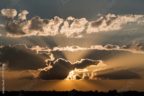 Sunlights radiant rays filter through dramatic cloud formations