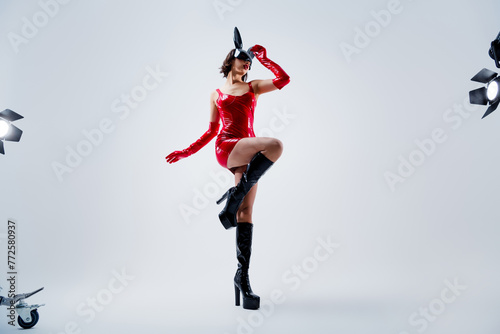 Full length photo of gorgeous girl dance striptease rabbit mask red leather outfit isolated on light gray background