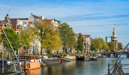 Channel in Amsterdam Netherlands houses river Amstel landmark old European city autumn landscape.