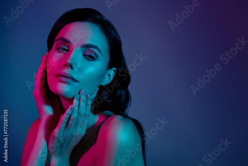 Photo of woman near copyspace touch face skin isolated over ultraviolet dark background