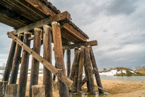 railroad timber trestle destroyed by river flooding - St Vrain Creek near Platteville, Colorado photo