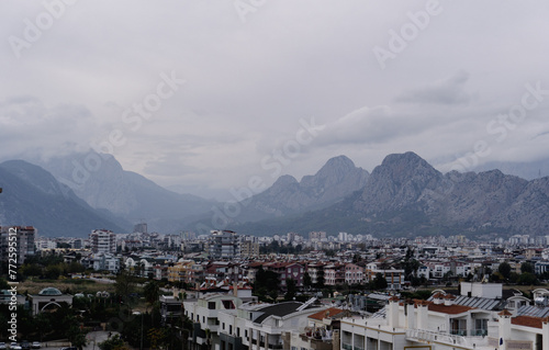 A city nestled amidst cloudy mountains © Maria