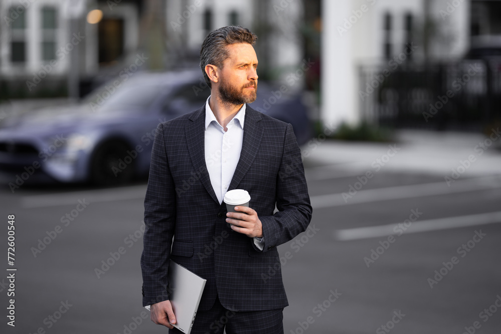 Business man in suit. Businessman walking in city. Hispanic man walk on street. Business man with laptop and coffee walking outdoor. Business man in suit go to office work. Success business.
