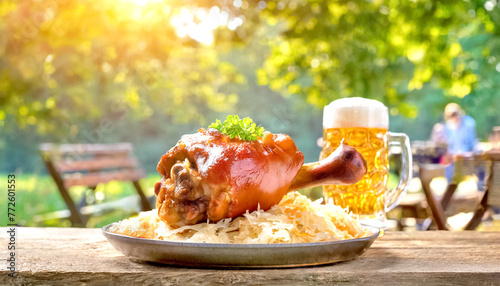 Schweinshaxe mit Sauerkraut und Bier im Biergarten  photo