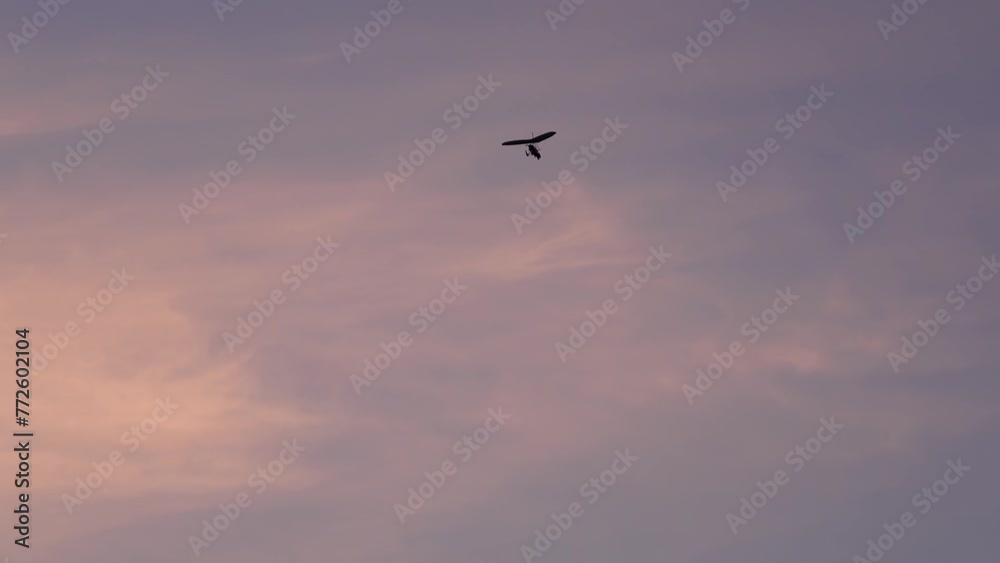 Motodeltoplan flies in the evening sky. Motodeltoplan flies in the evening sky.