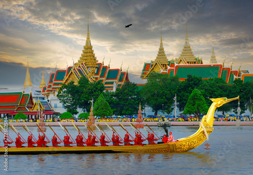 Traditional Thai Boat Procession under Partly Cloudy Skies, Golden Barge with Rowers in Bangkok photo