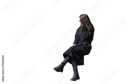 A woman in black coat in sitting pose isolated