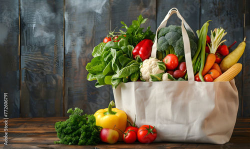 Tote bag full of different fresh, organic vegetables on the wooden background. Eco-friendly market and delivery concept © Alexey