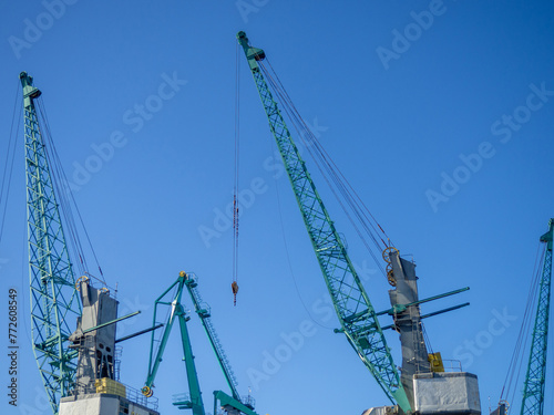 Marine cranes. Loading heavy loads. Cranes against the sky.