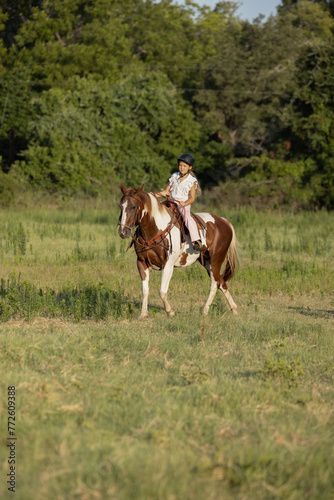 Little Girls with Horses riding western quarter horse and paint horse cowgirls in pink having fun