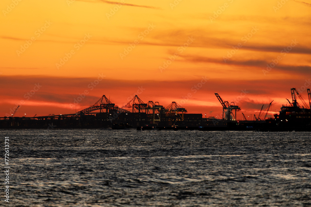 Commercial dock gantry cranes at sunset
