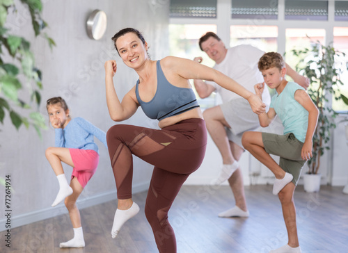 Parents with daughter and son practice dance moves in fitness class