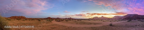 Panoramic image of a colorful sunset over the veld in southern Namibia with a pink play of colors