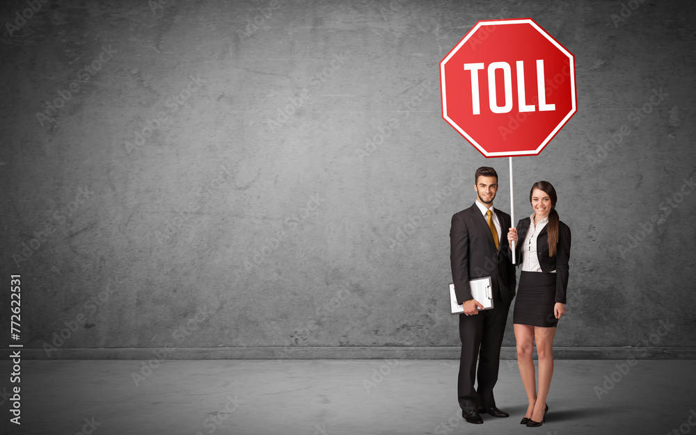 Young business person holding road sign Young business person holding road sign