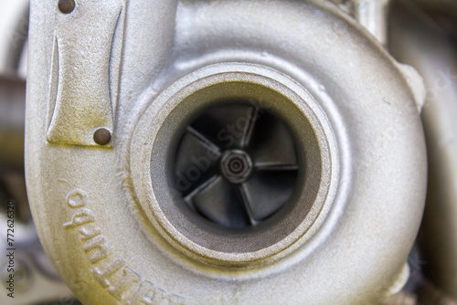 Detailed view of a turbocharger with its intricate blades, exemplifying the precision engineering of high-performance automotive technology