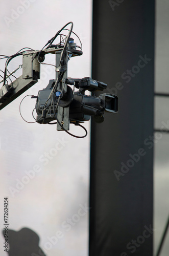 professional video camera on a crane covering an outdoor event