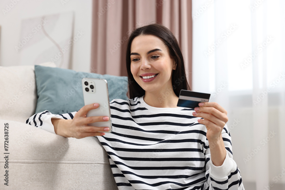Happy young woman with credit card using smartphone for shopping online at home Happy young woman with credit card using smartphone for shopping online at home