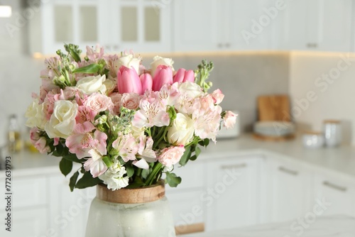 Beautiful bouquet of fresh flowers in vase indoors © New Africa